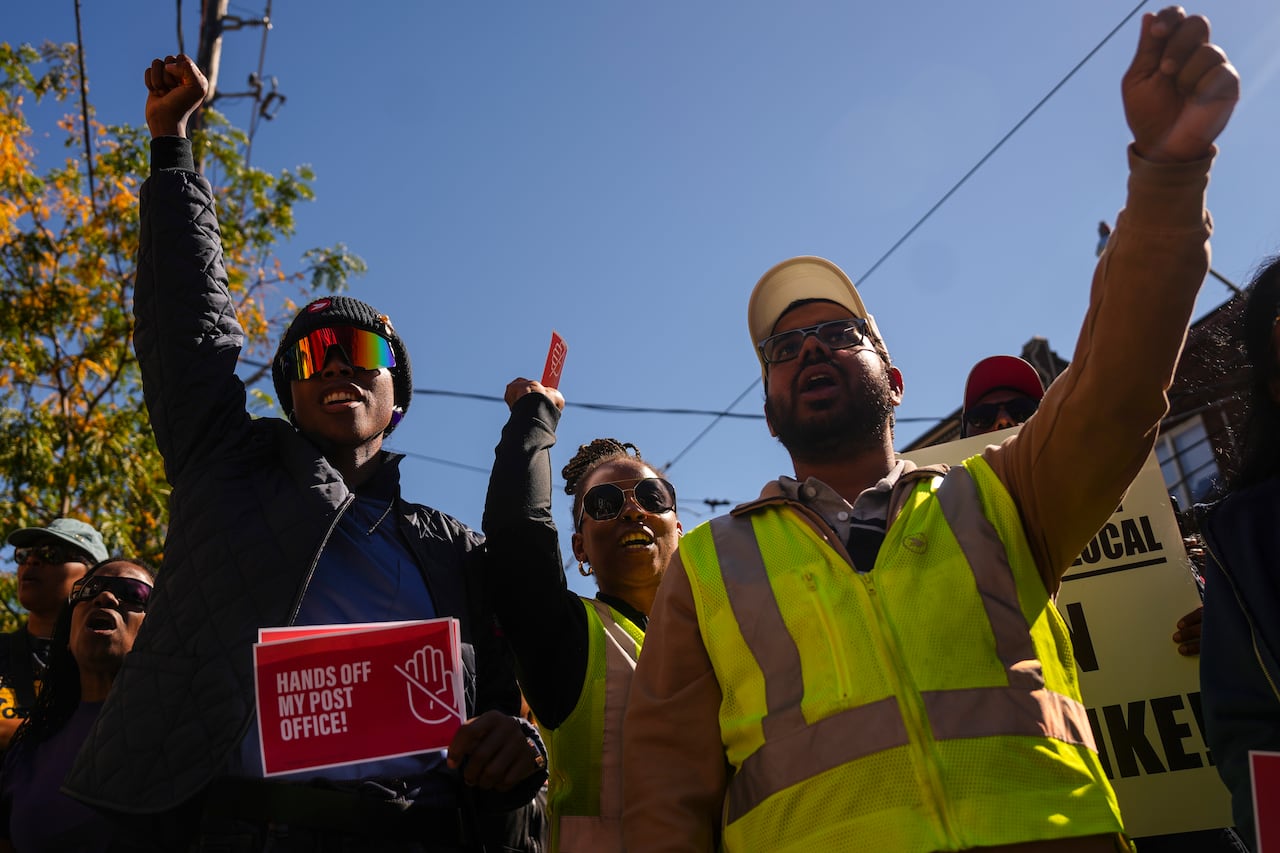 Protesters clasp  up   their fists.