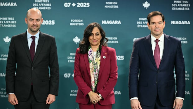 French Foreign Minister Jean-Noel Barrot, from left, his Canadian counterpart Anita Anand, and U.S. Secretary of State Marco Rubio pose for the family photo during the G7 Foreign Ministers' meeting at the White Oaks Resort in Niagara-on-the-Lake, Ontario, Canada, Tuesday, Nov. 11, 2025. (Mandel Ngan/Pool Photo via AP) Two men in suit and tie stand on either side of a woman in a maroon pant suit and scarf.