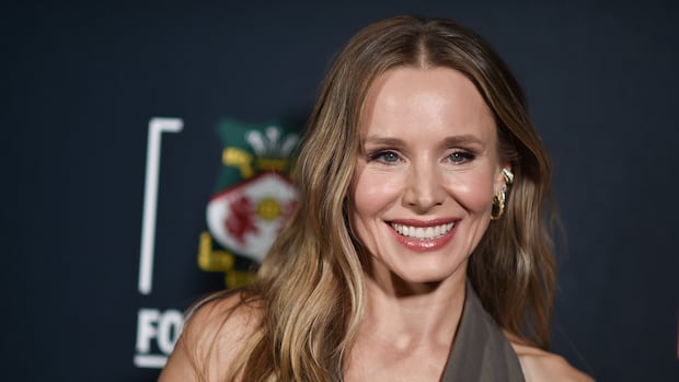 A woman smiles at the camera