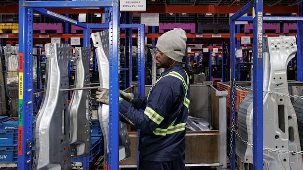 A worker transports truck door components at Martinrea auto parts, in Woodbridge, Ont., on Feb. 3, 2025. A worker transports truck door components at Martinrea auto parts, in Woodbridge, Ont
