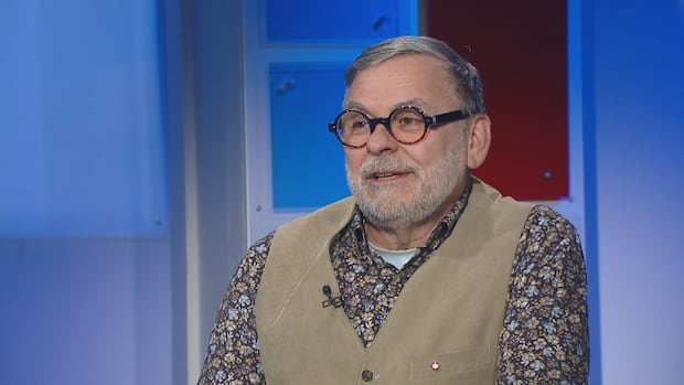 Rob Oakie is the executive director of Music P.E.I. A man with round glasses wearing a dark floral button-up shirt and a tan-coloured vest.