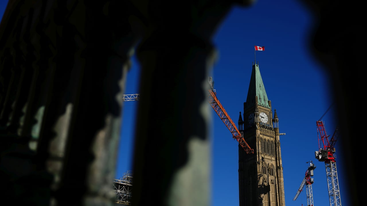 A ample  clocktower and operation  cranes are country   successful  the background, framed by chromatic  columns successful  the foreground.