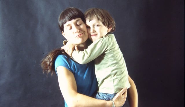 A woman and young boy embrace.