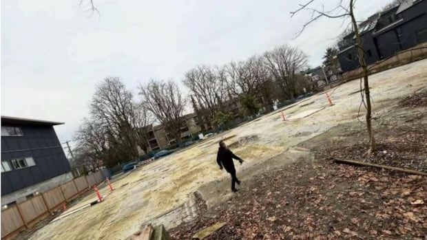The owner of an empty lot in East Vancouver wanted his property's assessed value cut in half from $19 million to $10 million. Unfortunately, he allegedly relied on artificial intelligence to bolster his case A man walks across an empty residential lot.