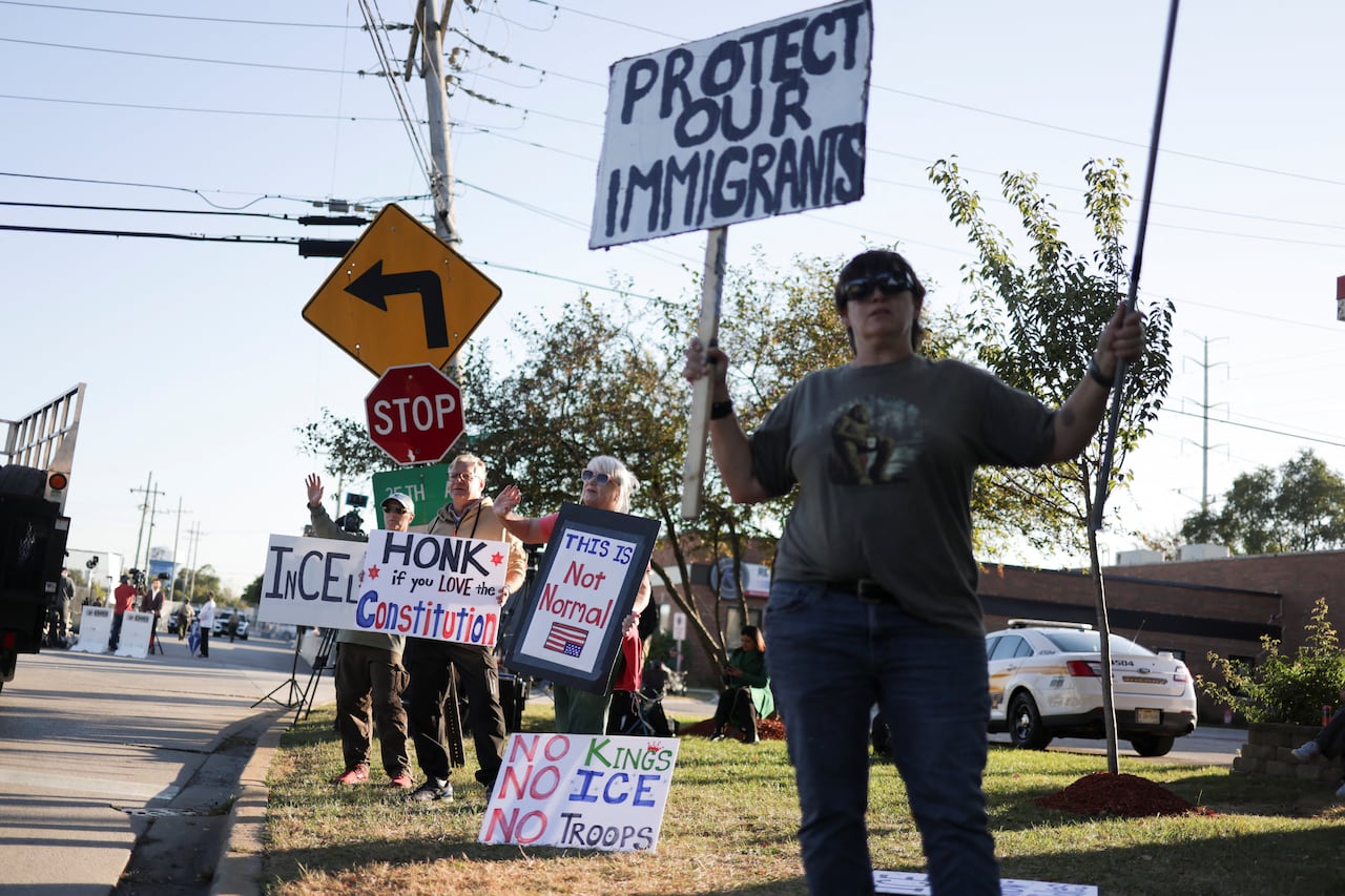 People hold signs of protest