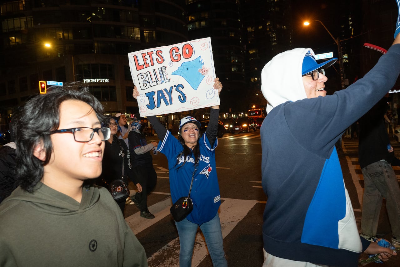 A group of Blue Jays fans celebrating a win in the street