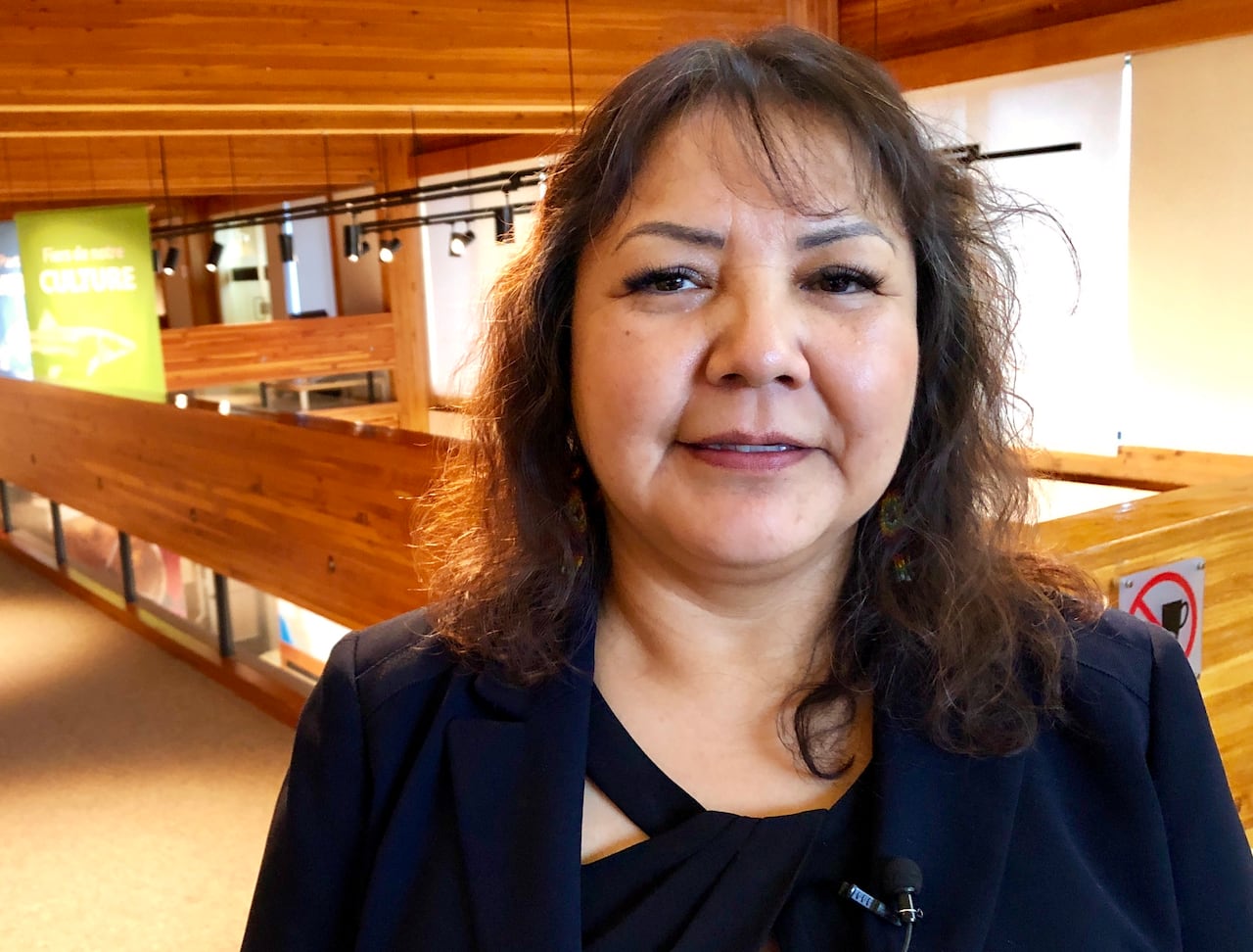 Woman smiles astatine  camera.