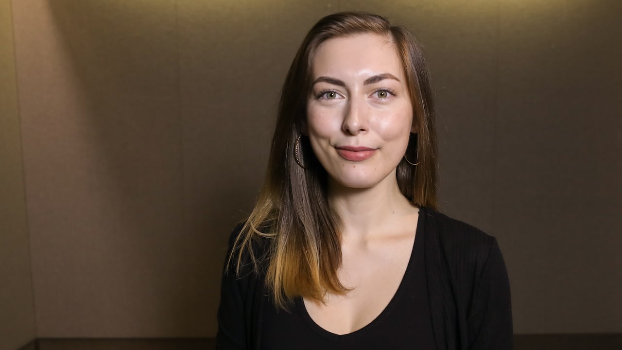 A smiling woman poses for a photograph.
