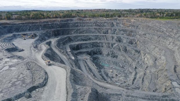 An aerial shot of an open-pit gold mine.