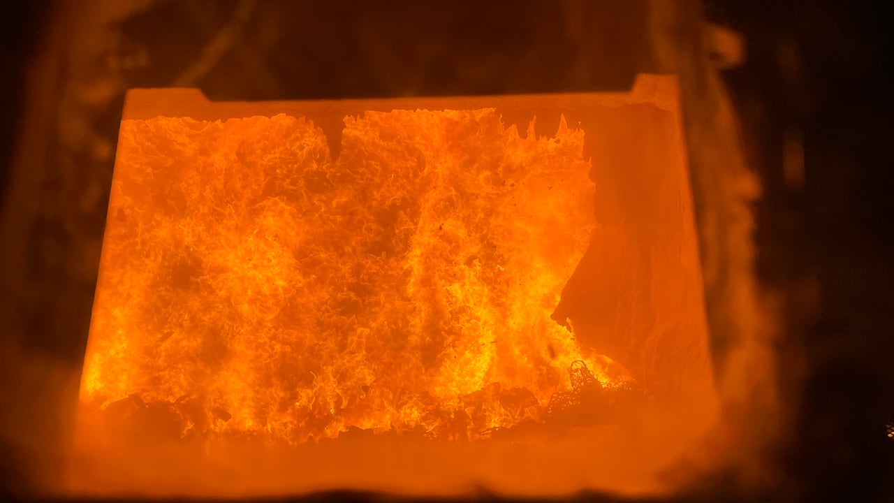 Huge orange flames are seen from the window of a boiler
