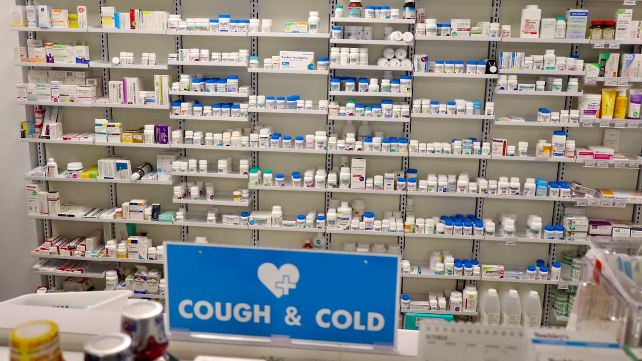 A pharmacy support  afloat  of medicine  with a motion   successful  the foreground that says "cough & cold."