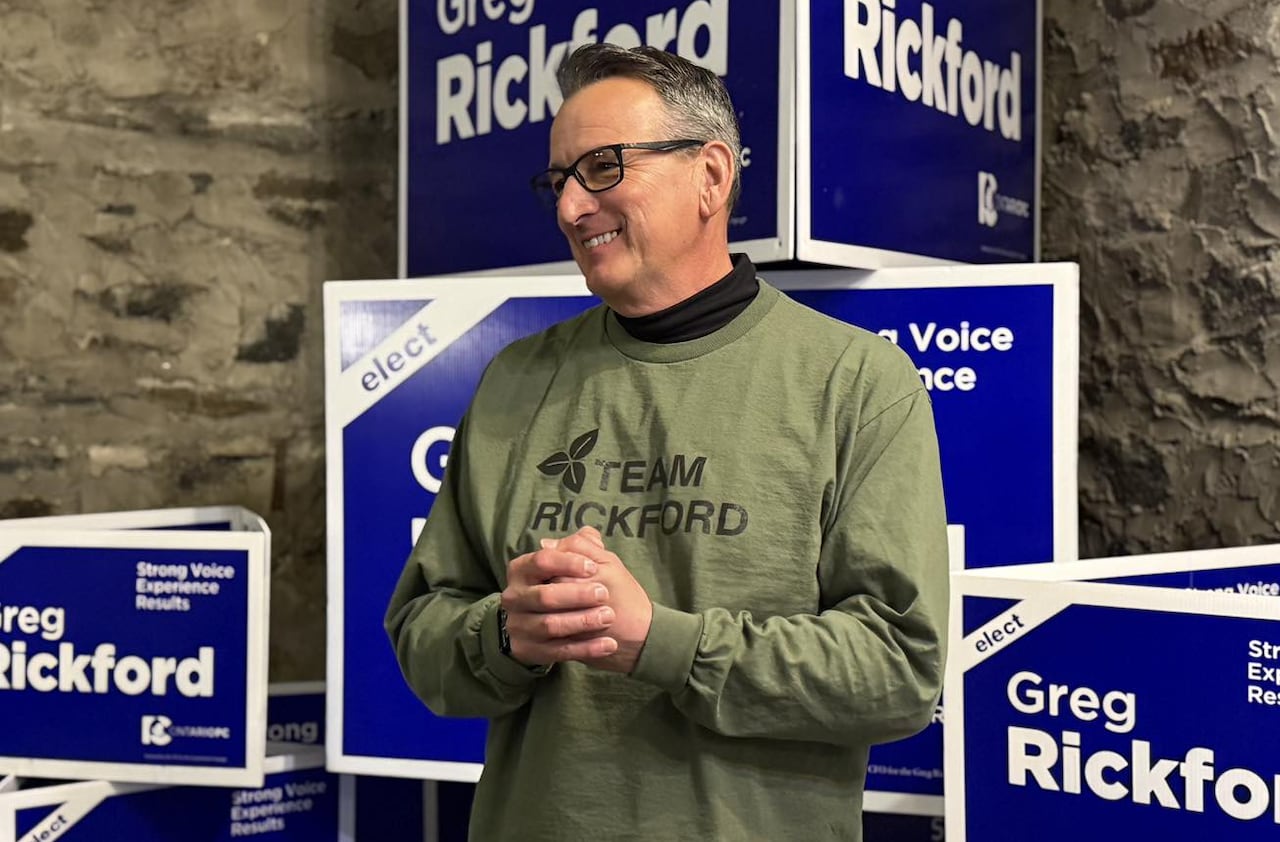 A man with glasses and a Team Rickford shirt smiles.