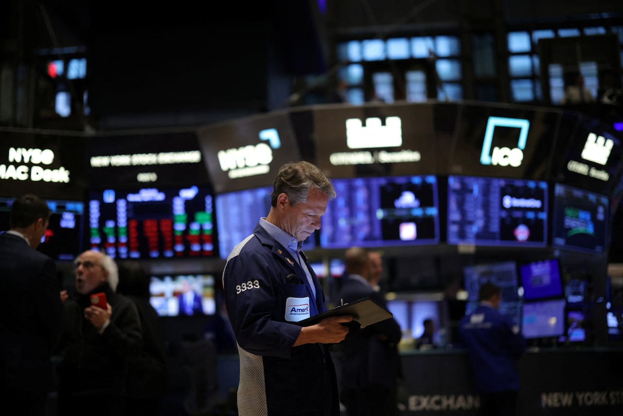 Traders work on the floor at the New York Stock Exchange.