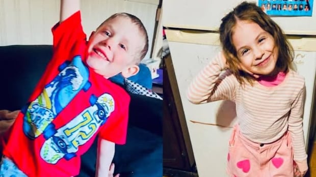Two children, a boy and a girl, smile.