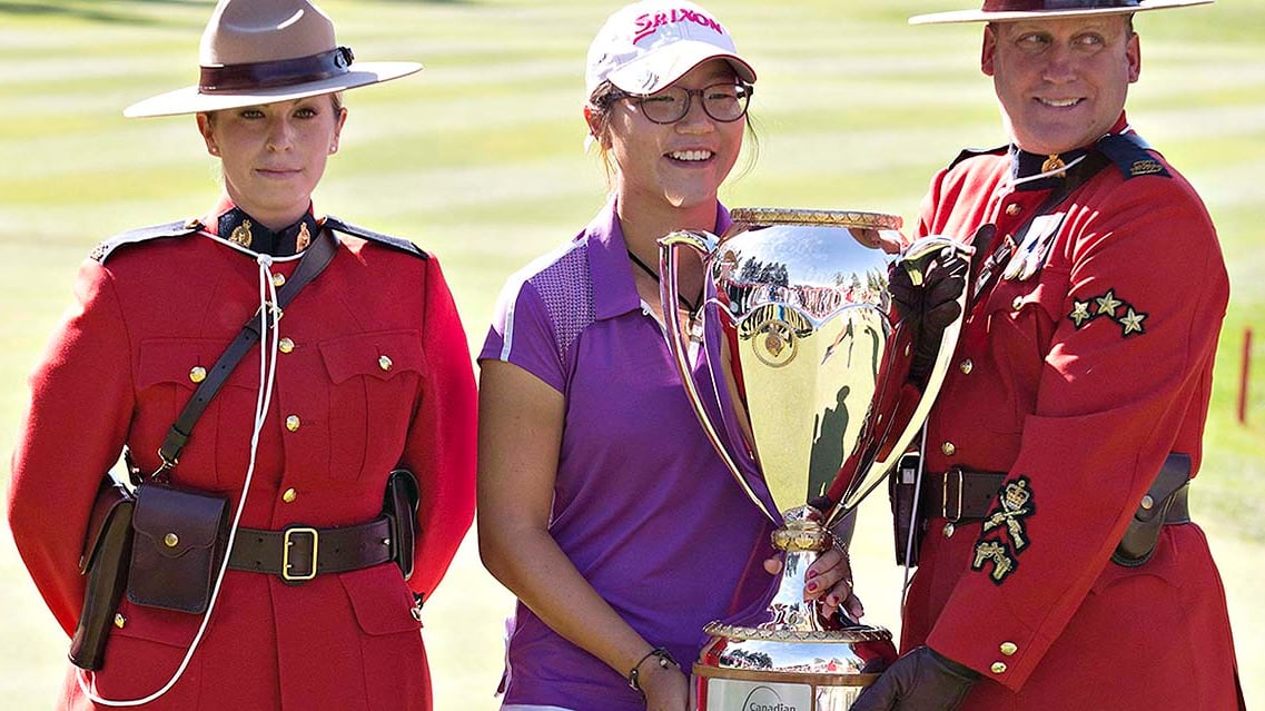 New Zealand women’s golfer Lydia Ko poses for a photograph  with the Royal Canadian Mounted Police aft  winning the LPGA Canadian Women's Open successful  Edmonton, Alberta connected  August 25, 2013.
