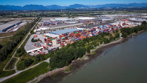 An overhead view of an industrial yard with a number of cargo containers.
