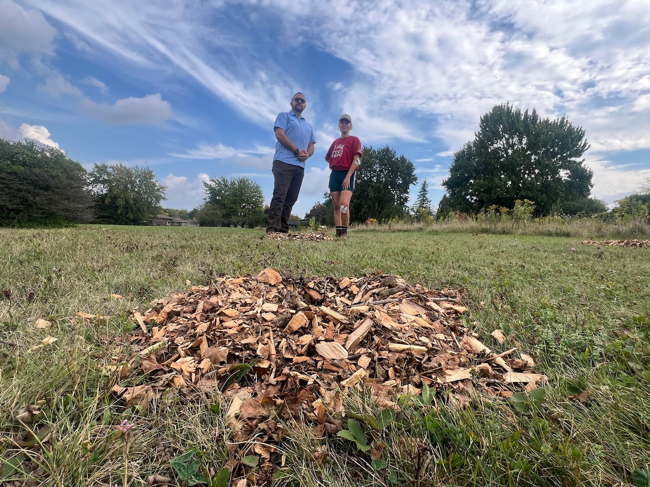 Roger Moran and Devin Way of ReForest London stand behind one of the mulch circles that indicate where trees planted on Friday were ripped out over the weekend. The trees were planted on a hill in Arthur Ford Park.
