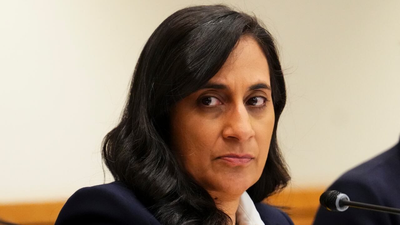 An Indian woman with black hair looks somewhere out of frame.