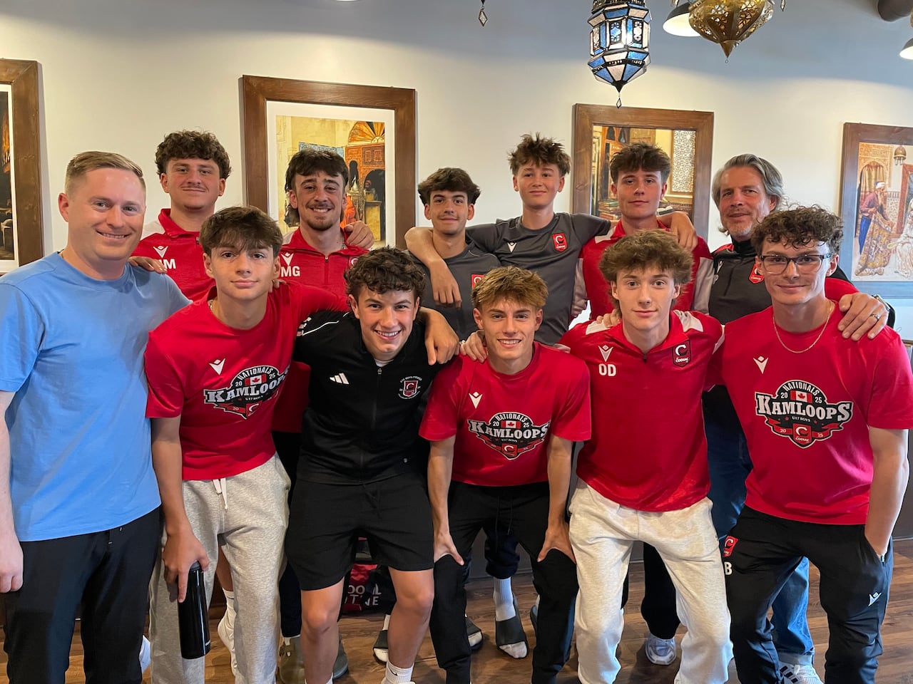 A radical  of 10 teenage boys successful  2  rows grin  with their arms astir   each   other. On 1  extremity  of each   enactment      is an big  coach. Most of the boys are wearing shot    jerseys oregon  t-shirts.