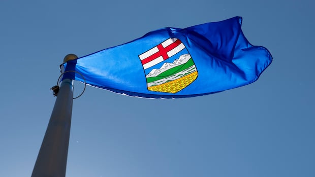 Alberta's provincial flag flies on a flag pole in Ottawa, Monday July 6, 2020. A blue flag with a blue sky.