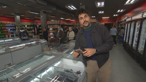 Gabriel Guinty stands in a grocery store. 