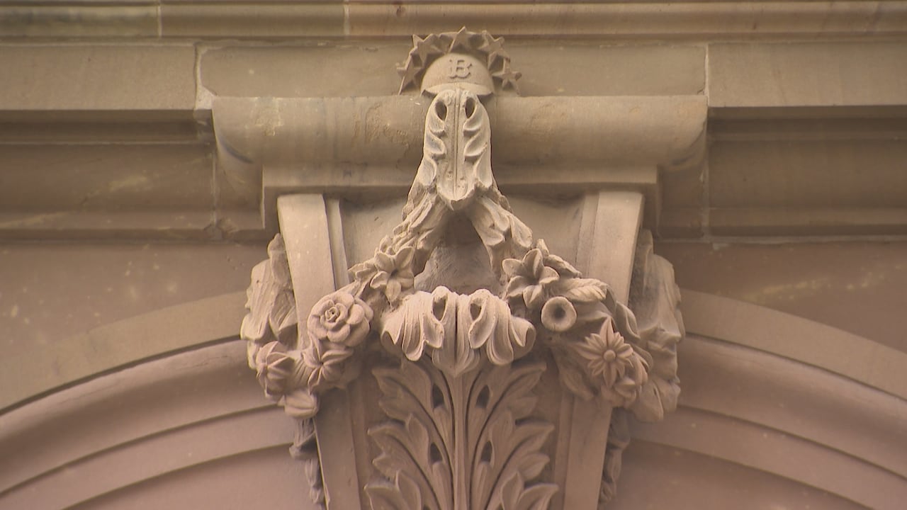 A stone carving featuring a baseball cap with the signature logo of the Boston Red Sox baseball team.