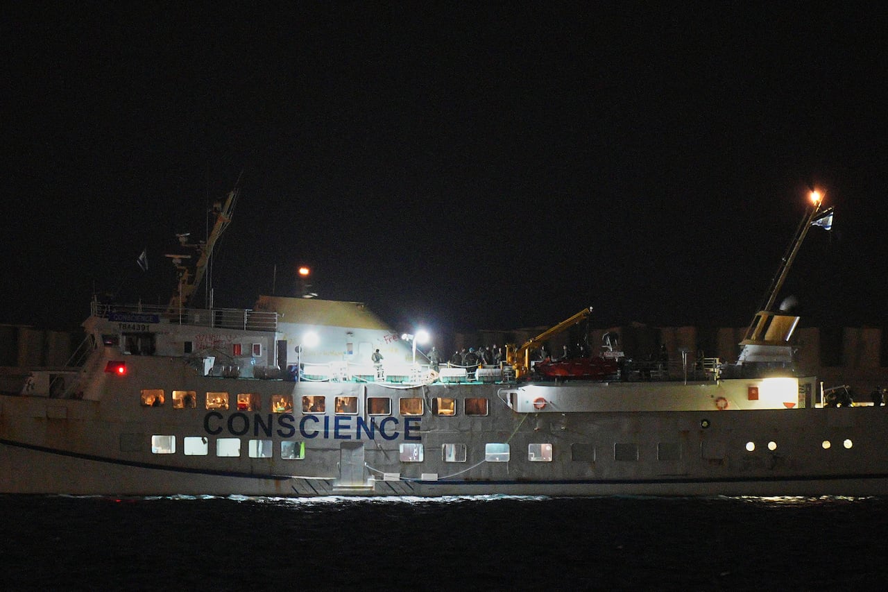 A large boat is seen at night on the water.