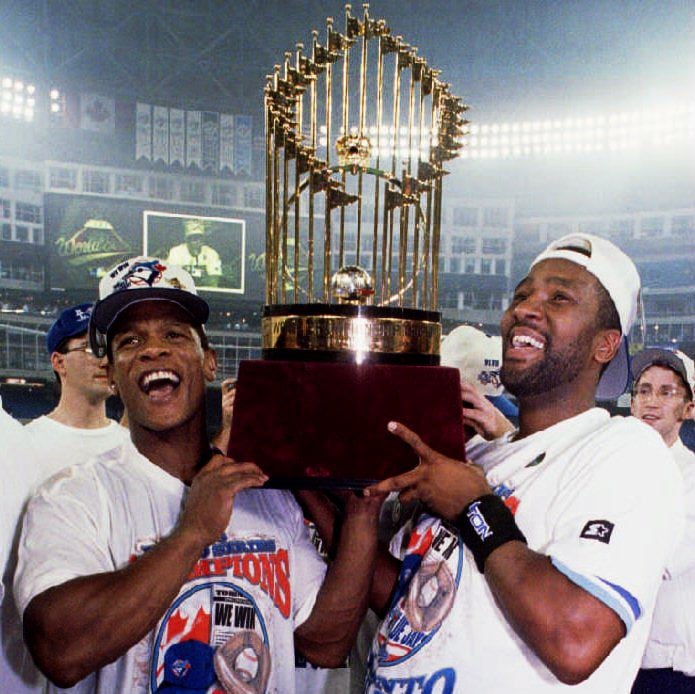 Two athletes holding a trophy