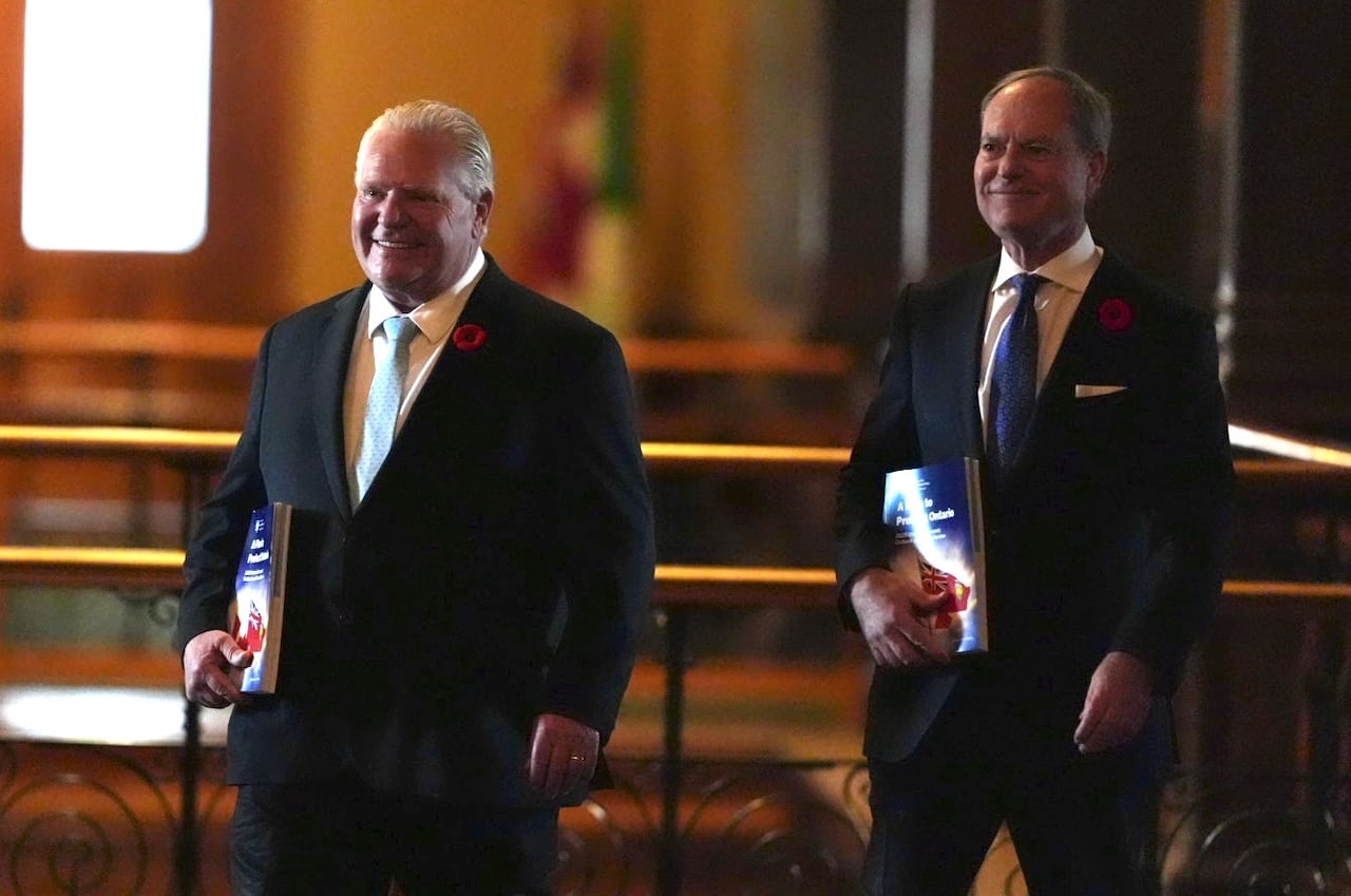 Two men lasting successful suits with books successful hand