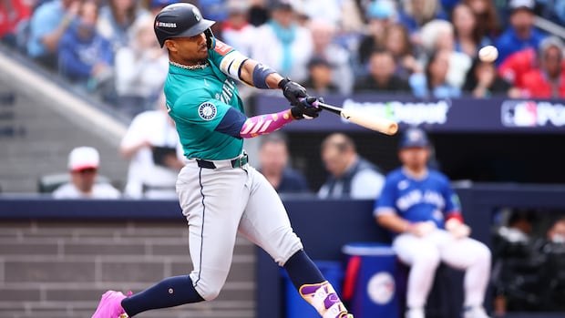 A baseball player hits a home run.