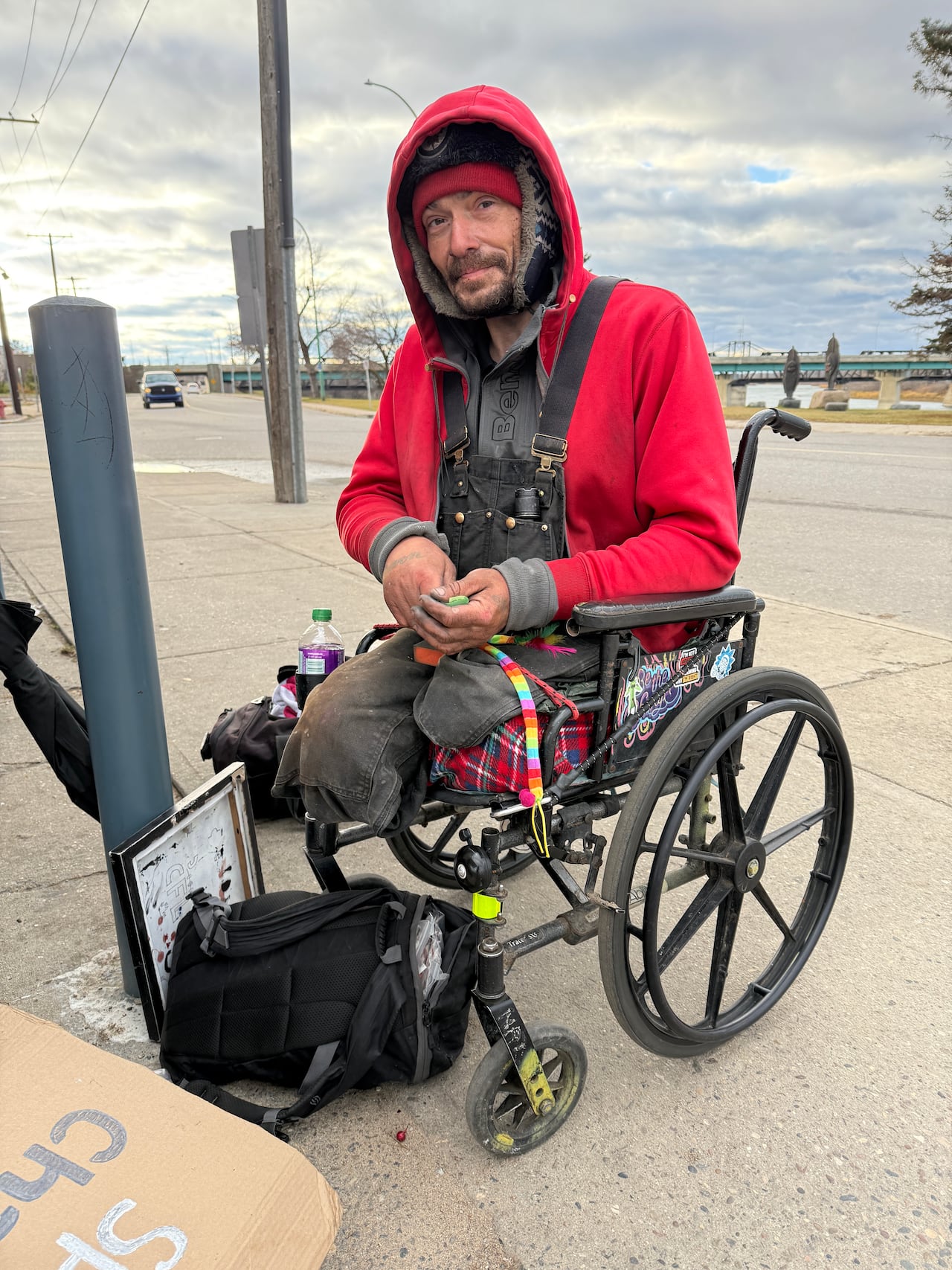 A antheral   successful  a wheelchair with amputated legs connected  the sidewalk extracurricular  a store