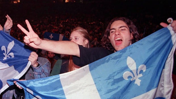 A Yes supporter holding a Quebec flag chants nationalist slogans prior to a concert of Quebec rock stars in support of sovereignty in Montreal Friday Sept. 29, 1995. 