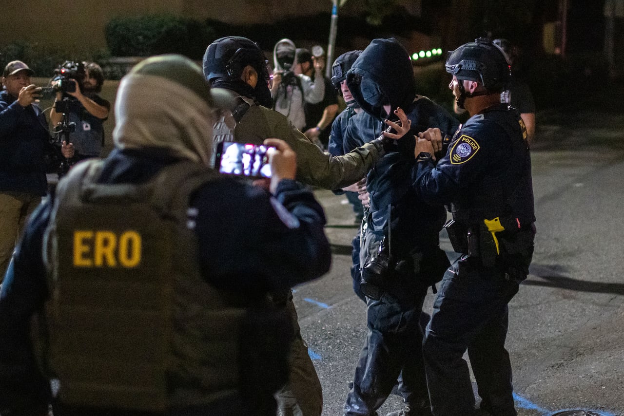 Police in Mask and Uniforms arrested a person at night