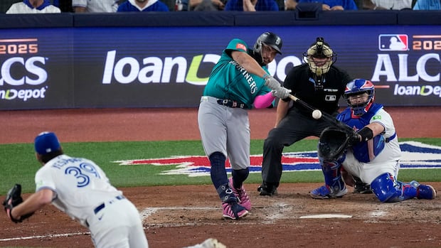 A batter connects his bat to the ball on a baseball diamond.