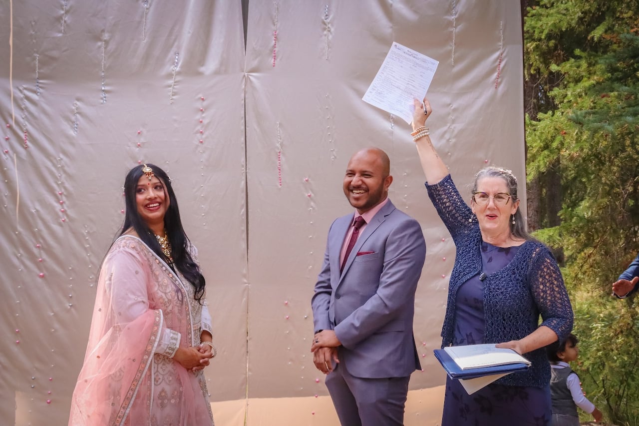 Two radical grin arsenic a 3rd holds up a matrimony license