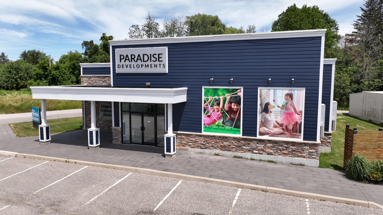 A blue building with a sign that says Paradise Developments.