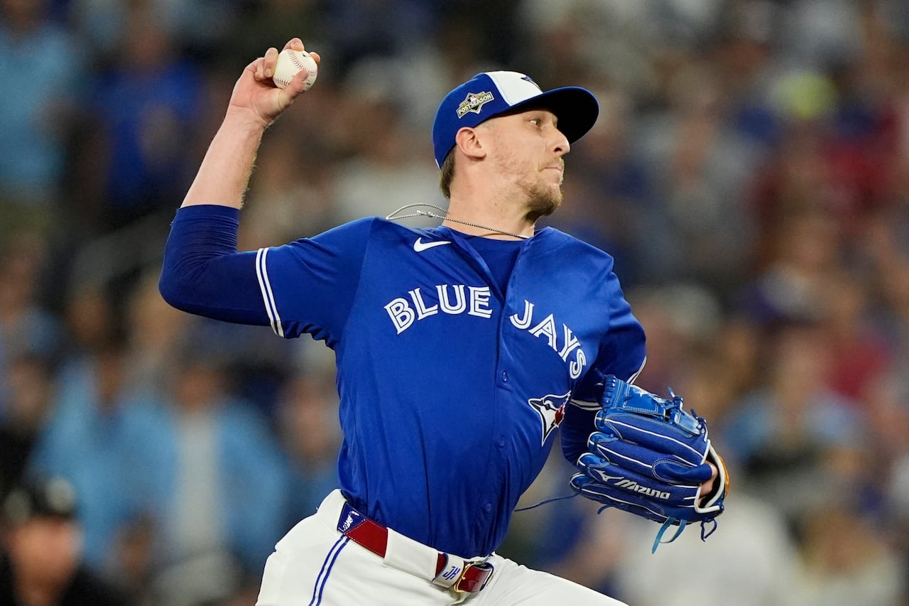 A baseball pitcher throwing a baseball