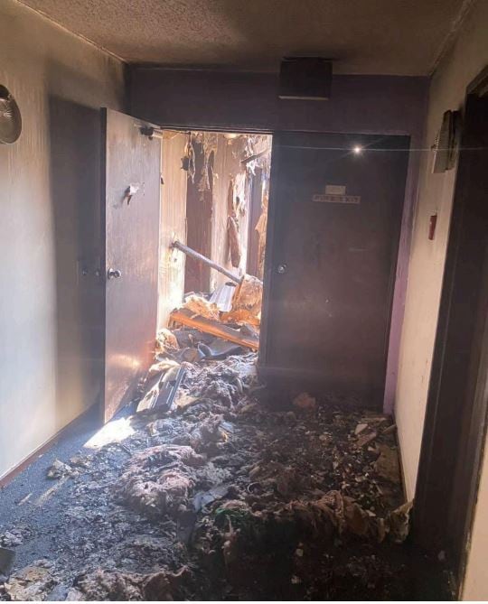 A set of stairs in a fire-ravaged basement.