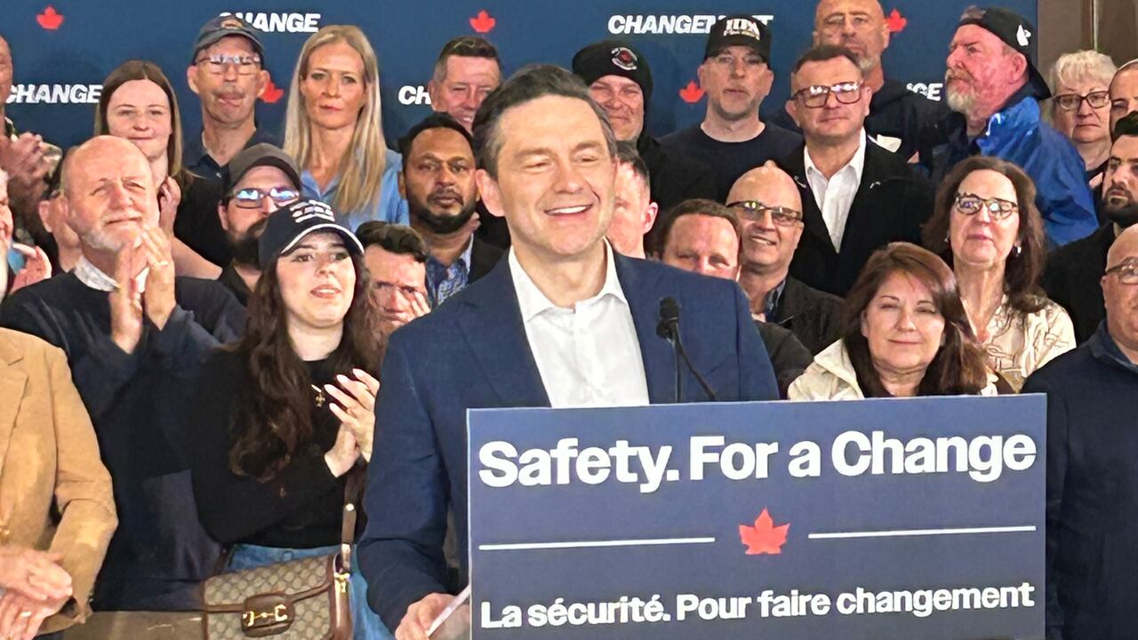 A antheral   stands astatine  a podium with a motion   that says 'Safety. For a Change'.
