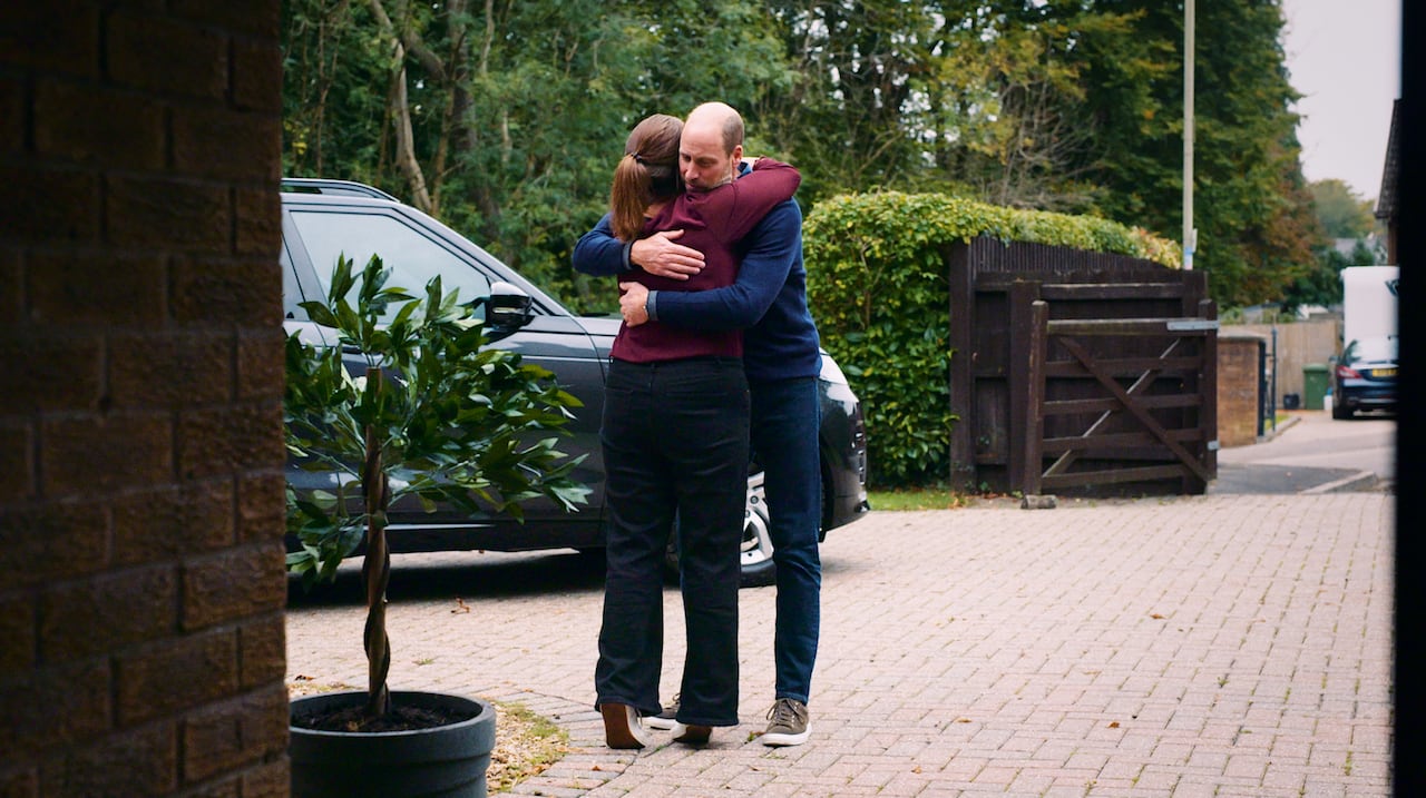 Two people hug.