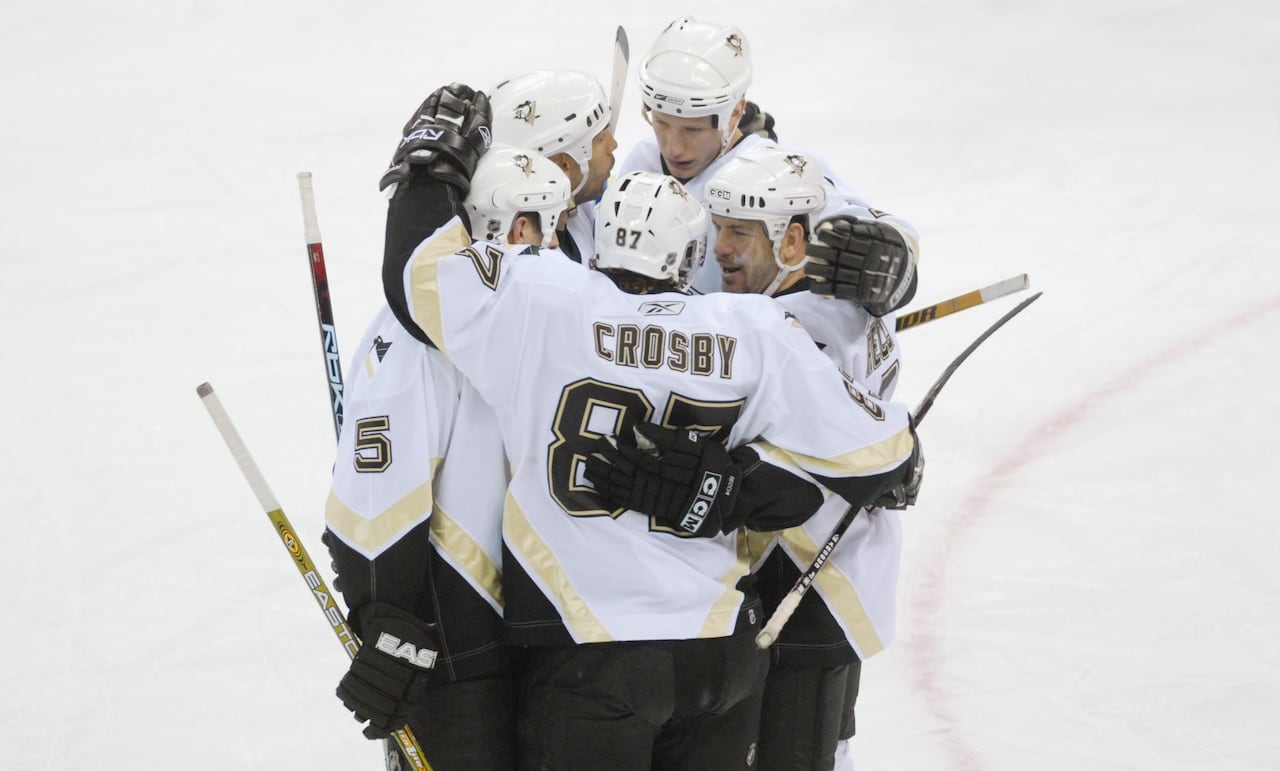 Sidney Crosby, 87, celebrates his 200th career point in a game on March 2, 2007, with teammates, including Alain Nasreddine, second from left.