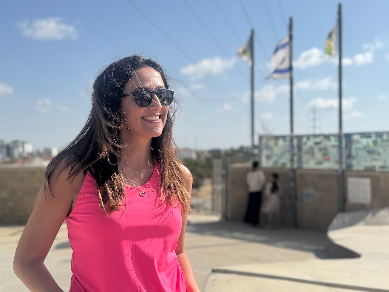A person is seen smiling at a lookout point.