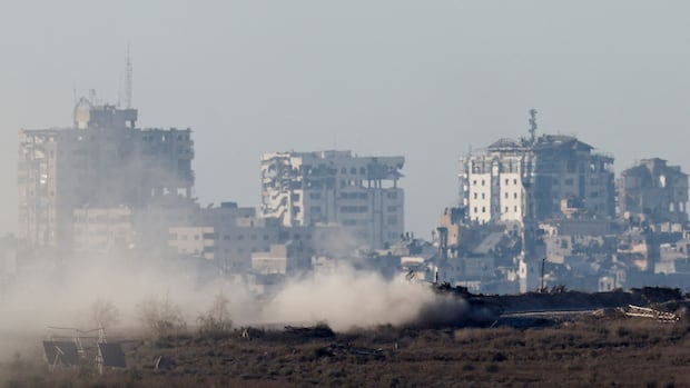 The tank defends dusty ground in front of the destroyed buildings.