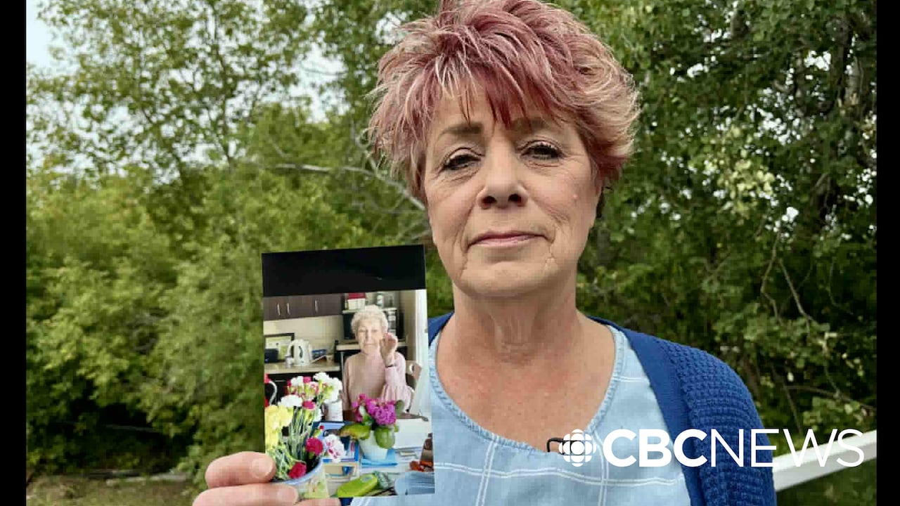 Leona Heisler holds an image of her late mother Norma Wensley
