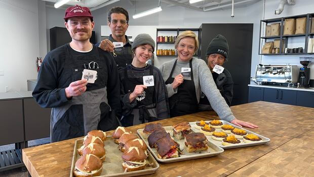 Upward Kitchen and Café at the Nook is making healthy meals for people on a budget in the neighbourhood. Gareth Hampshire has the story. 5 people stand next to three trays of food