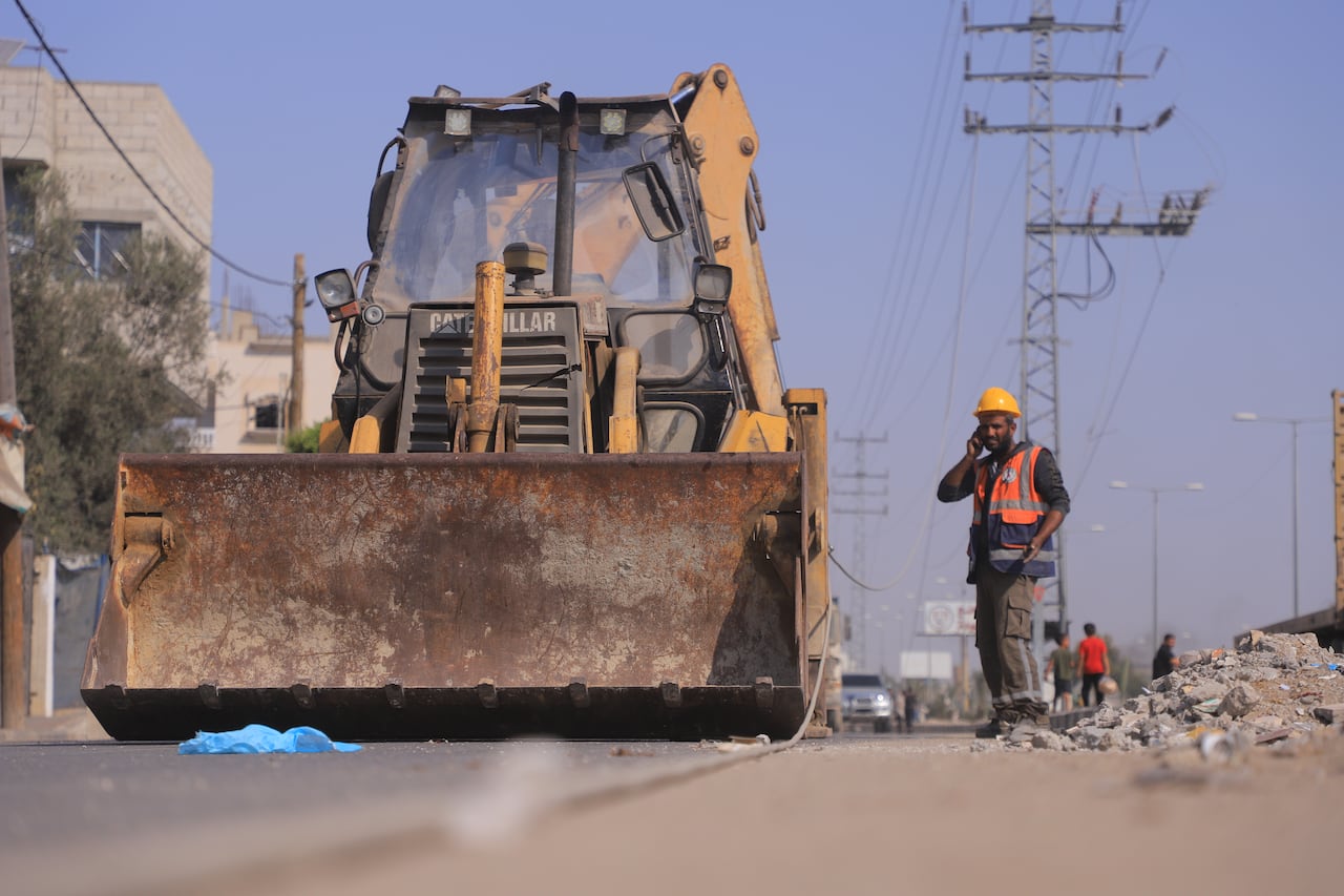 A man is standing next to a tractor