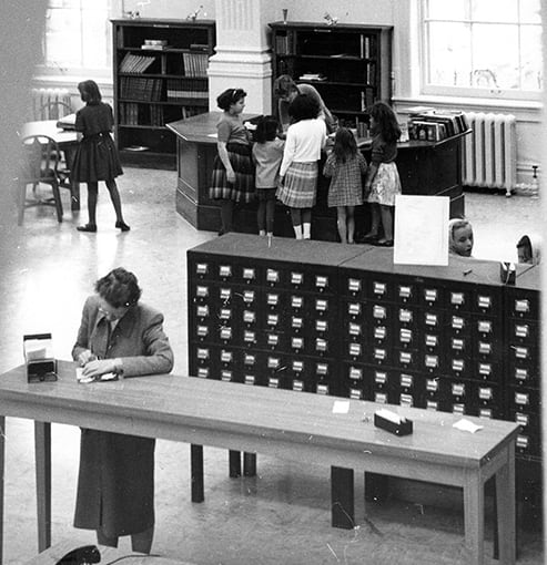 Black and white photo inside an old library