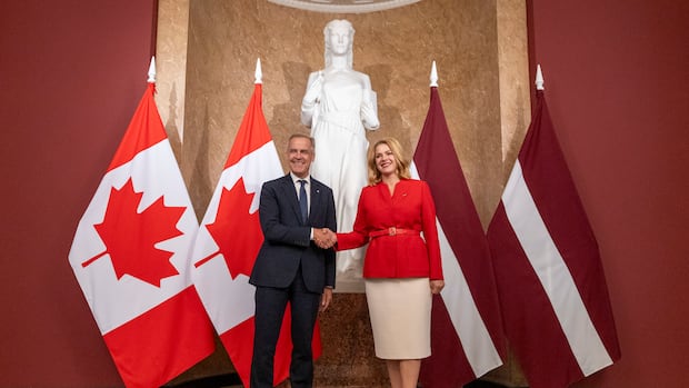 Prime Minister Mark Carney shakes hands as he meets with Latvian Prime Minister Evika Silina