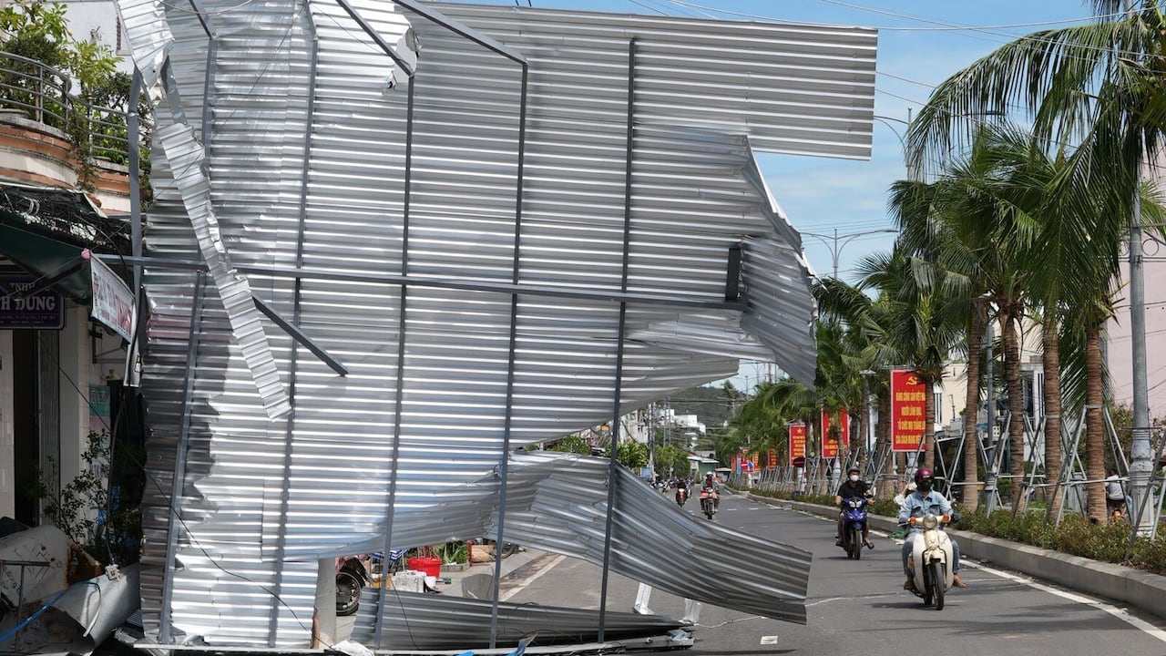 A monolithic metallic extortion is connected its broadside and onto a engaged metropolis street, with radical shown riding scooters astir it.