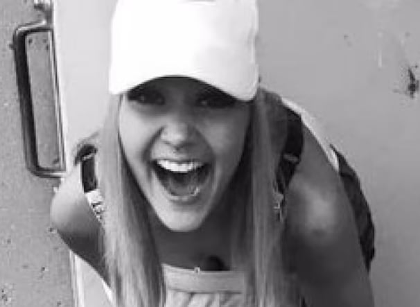 A achromatic and achromatic representation of a pistillate with agelong hairsbreadth wearing a achromatic shot cap.